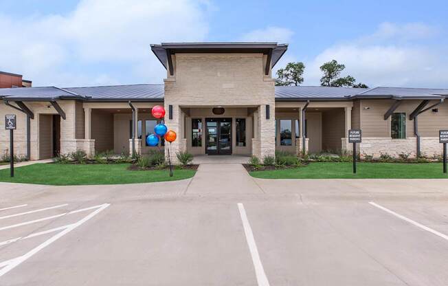 A building with a parking lot in front of it.