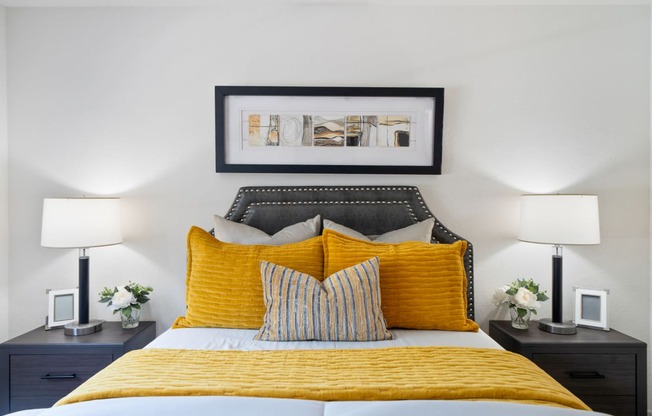 a bedroom with a yellow bed and yellow pillows