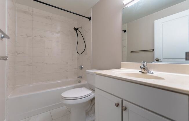 a bathroom with a sink toilet and a bath tub