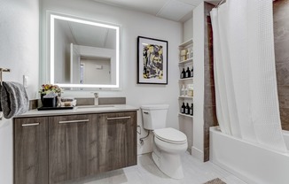 a bathroom with a toilet and a shower and a sink