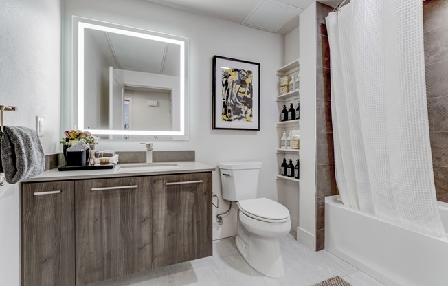 a bathroom with a toilet and a shower and a sink