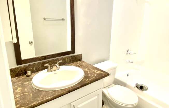 Bathroom vanity sink and mirror full bathtub and shower  at Parc Meridien, Los Angeles