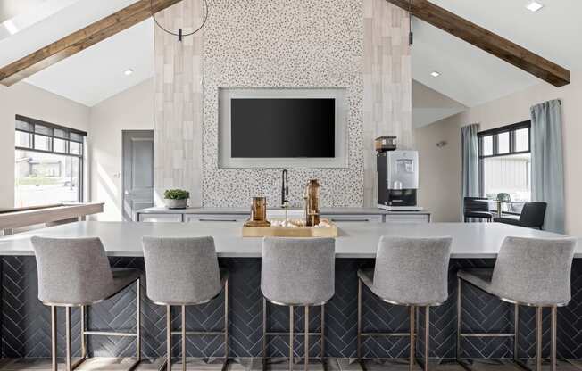 a kitchen with a marble counter top and chairs