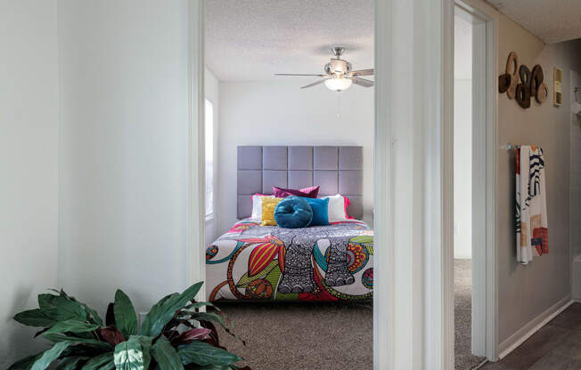 a bedroom with a bed and a ceiling fan