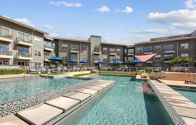 A swimming pool surrounded by apartment buildings.