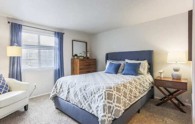 A bedroom with a large bed and a white couch.