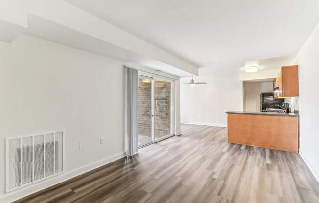 a living room with a wood floor and a sliding glass door