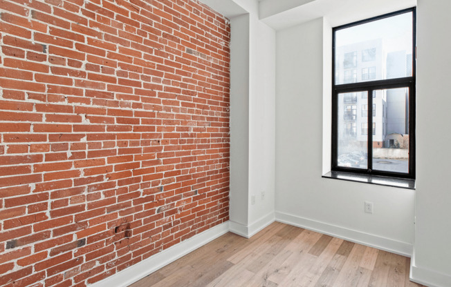 Experience contemporary urban living with this stylish exposed brick feature.