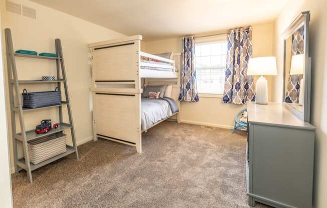 a bedroom with a bunk bed and a desk with a lamp at Chapel Valley Townhomes, Baltimore Maryland