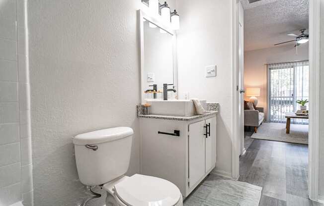 a large white bathroom with a toilet and a sink