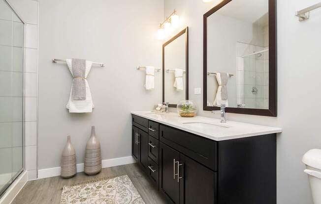 A bathroom with a white sink and a mirror above it.