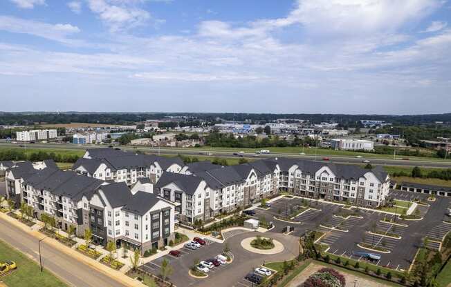 an aerial view of an apartment complex with a parking lot