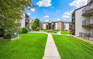 Beautiful community walkways between apartment buildings at Greensview Apartments in Aurora, CO