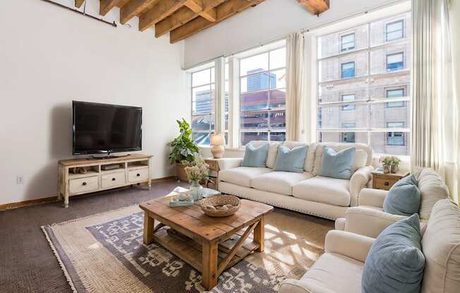 a living room with couches and a table and a television