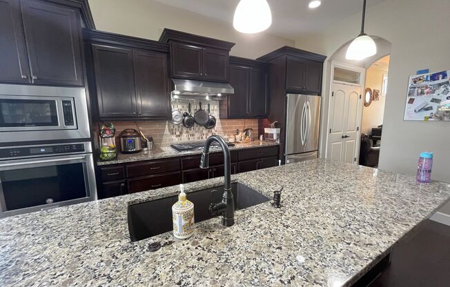 Stylish 5-Bedroom Home with Modern Kitchen, Stone Fireplace & Luxurious Primary Suite