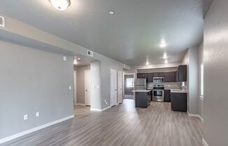 a kitchen and living room with a hardwood floor