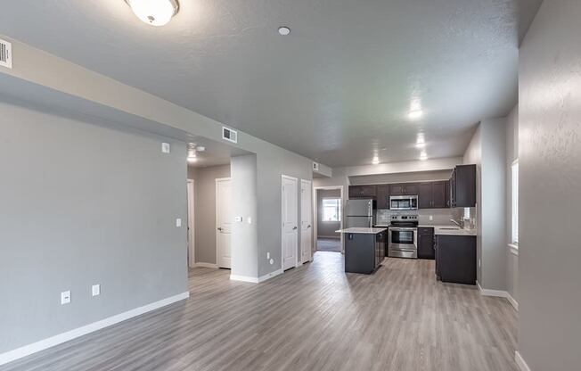 a kitchen and living room with a hardwood floor