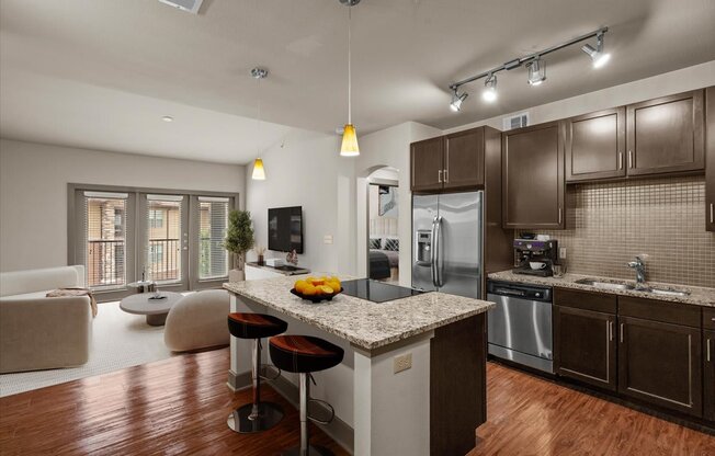 kitchen and living room at the district flats apartments in lenexa, ks