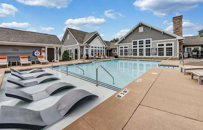 the reserve at the crossings apartments pool and building with lounge chairs