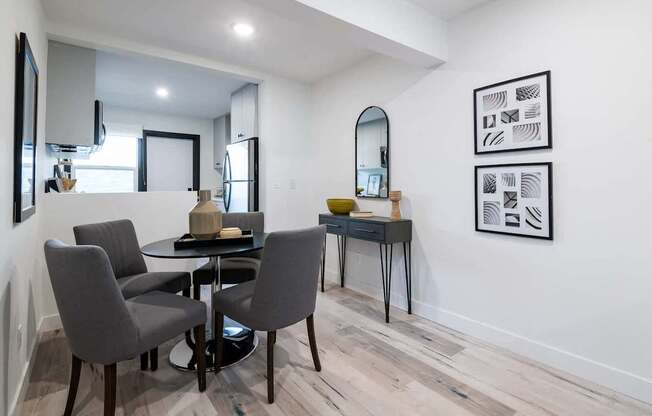 A dining room with a table and chairs.