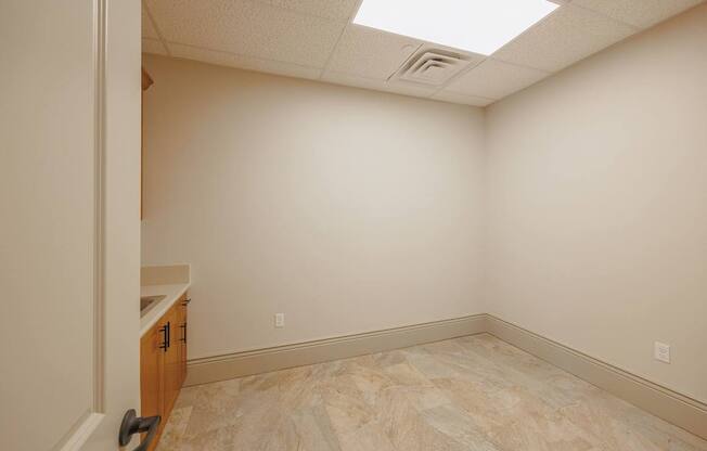 A room with a marble floor and a skylight.