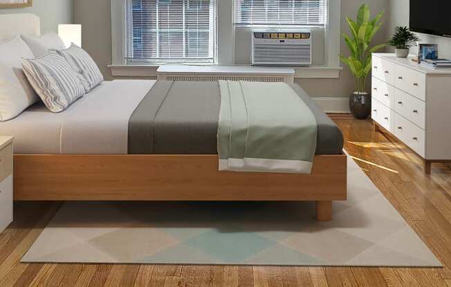 A bedroom with a bed, a dresser, and a window.