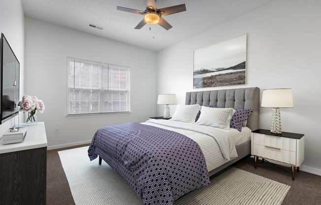 a bedroom with a bed and a ceiling fan