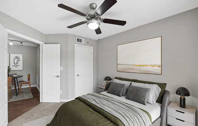 Model Bedroom with Carpet and View of Dining Room Area at Fountains Lee Vista Apartments in Orlando, FL.