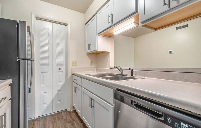 Upgraded kitchen with pantry and breakfast bar at West Wind Apartments in Fort Wayne, IN