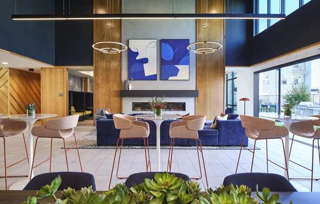 the lobby of a hotel with tables and chairs