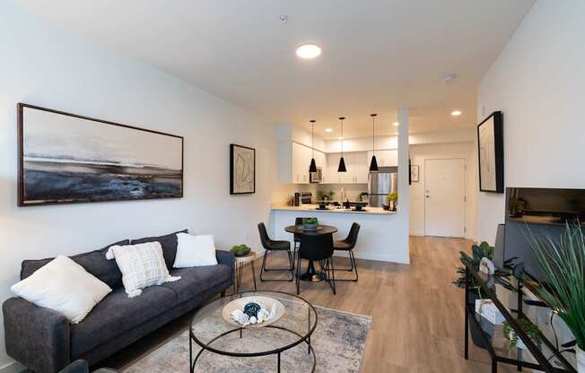 A living room with a grey couch and a coffee table.