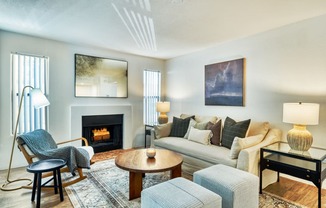 a living room with a couch and chairs and a fireplace