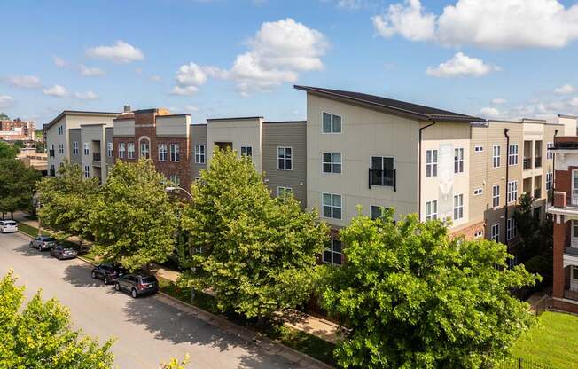 A row of townhouses with trees in front of them.