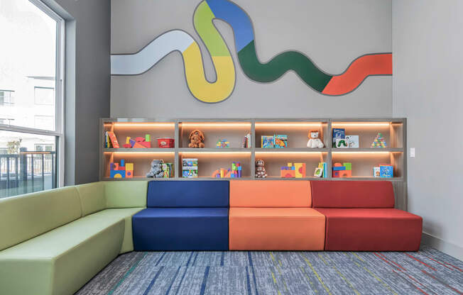 the lobby of a childrens library with colorful couches