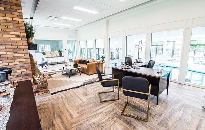 A modern office space with a brick wall and wooden flooring.