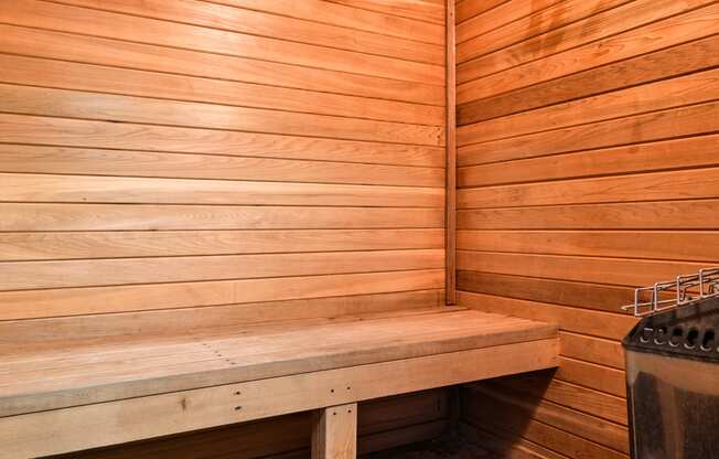 a wooden sauna with a bench and stove