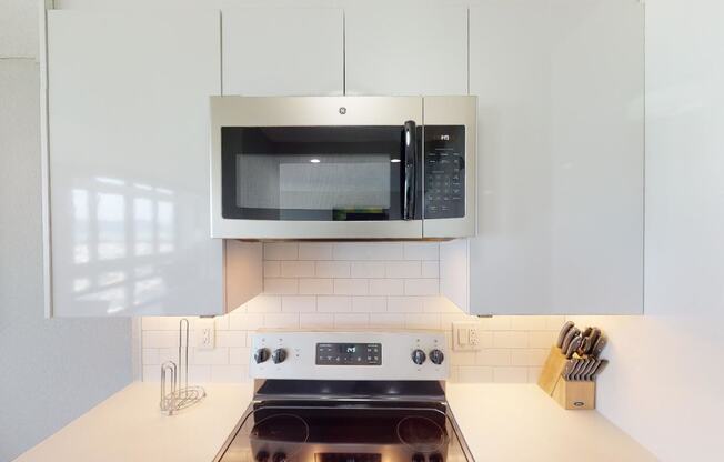 a kitchen with a stove and a microwave