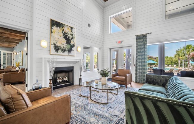 A living room with a fireplace and a painting on the wall.