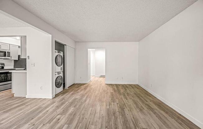 an empty room with a washer and dryer