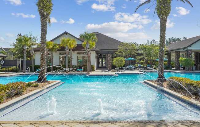 A pool with a fountain in the middle of it.