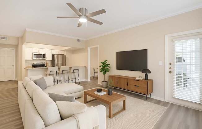 A living room with a white couch and a wooden coffee table.