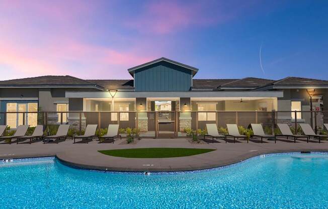 A modern house with a swimming pool in front.