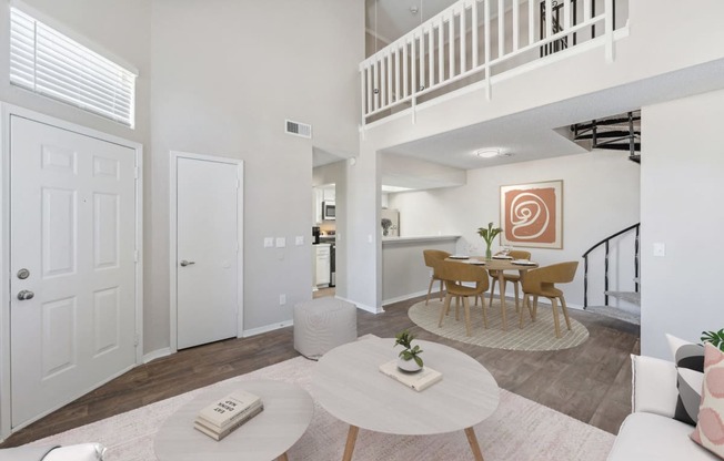 a living room with a dining room and a staircase