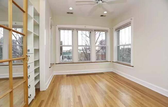 an empty living room with a closet and a window at The Bryant at Oak Park I & II, Illinois, 60302