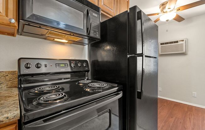a kitchen with a stove and a refrigerator