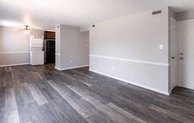 A room with a wooden floor and white walls.