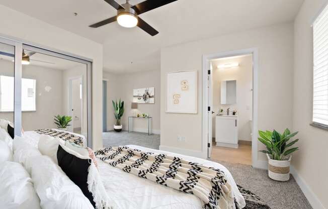 a bedroom with a large bed and a ceiling fan