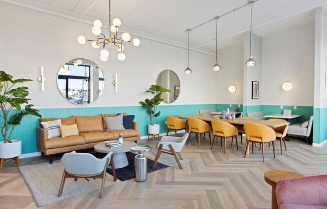 A room with a couch, chairs, and a table.