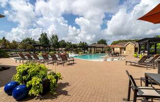 A pool area with a table and chairs.