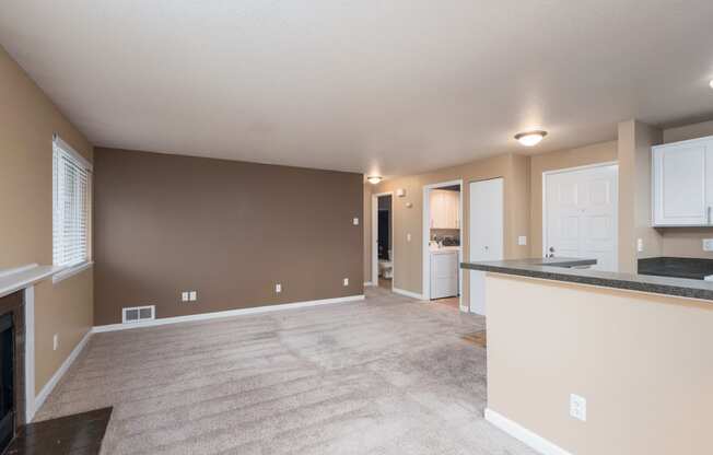 the living room and kitchen of an empty house